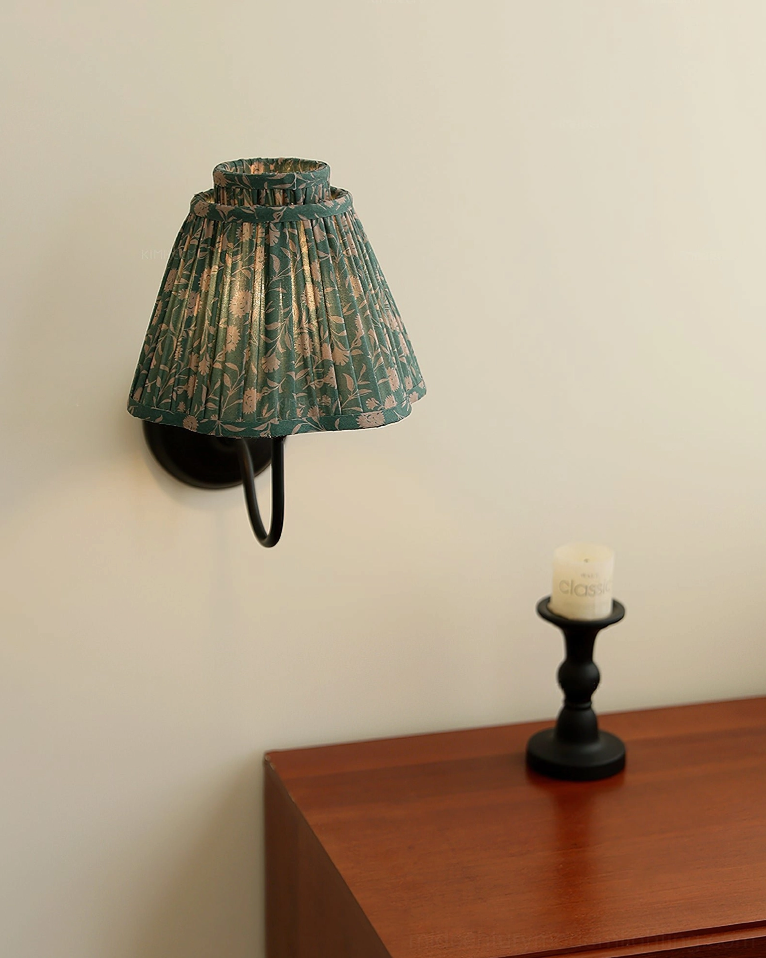 Elbow wall sconce with pleated shade and curved arm, architectural detail and design feature