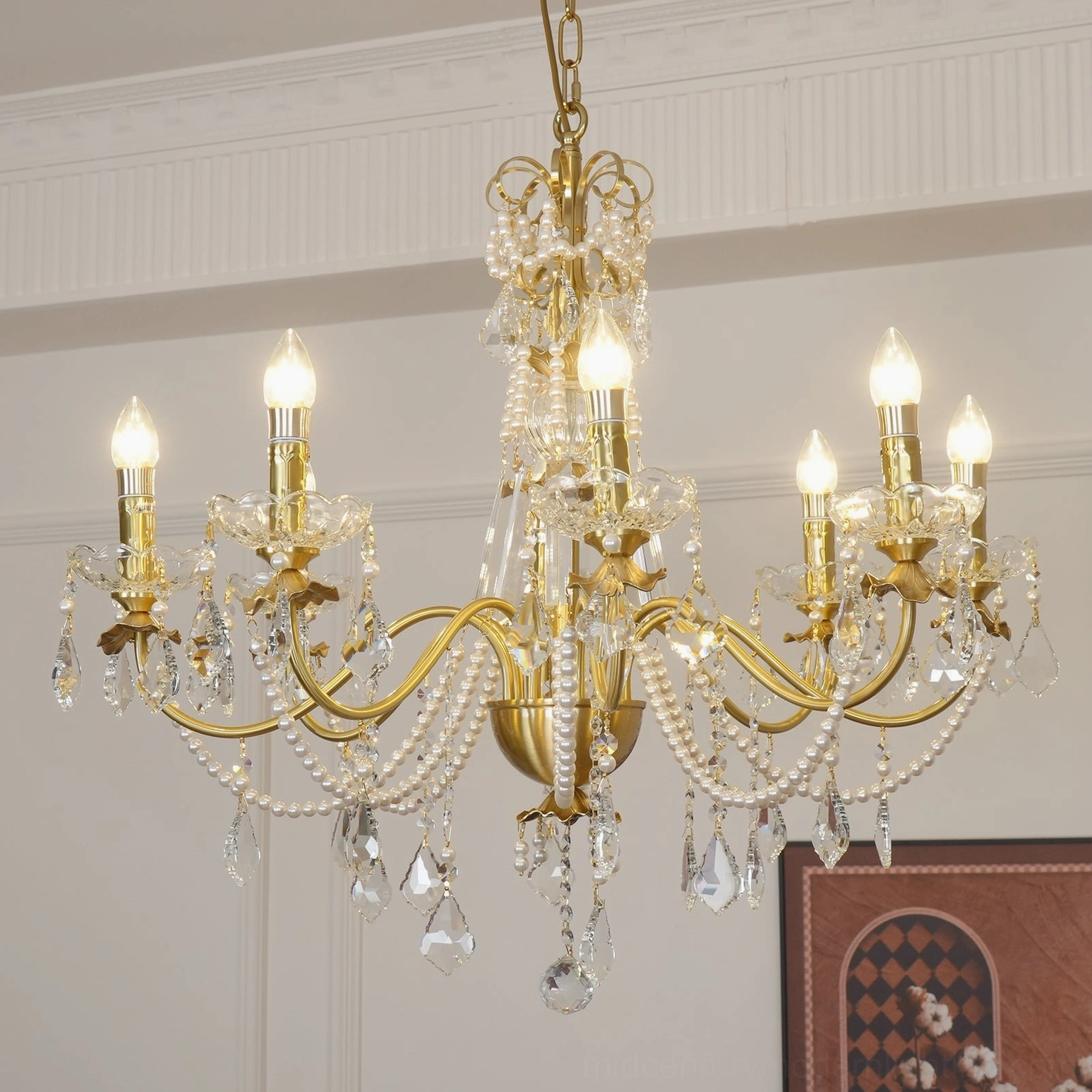 Elegant brass crystal chandelier with candle-style lights and delicate faceted crystal pendants hanging