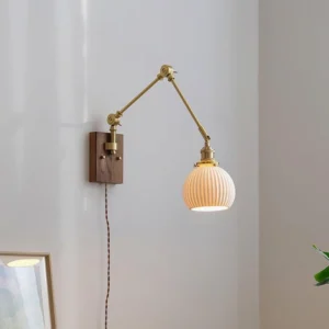 Elia swing arm plug-in wall lamp installed in home corner with ribbed glass shade and warm brass hardware