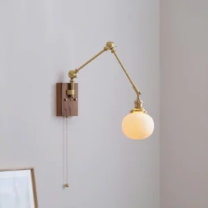 Mid-century modern swing arm wall lamp installed in minimalist home corner with framed artwork, brass arms and ribbed glass shade detail