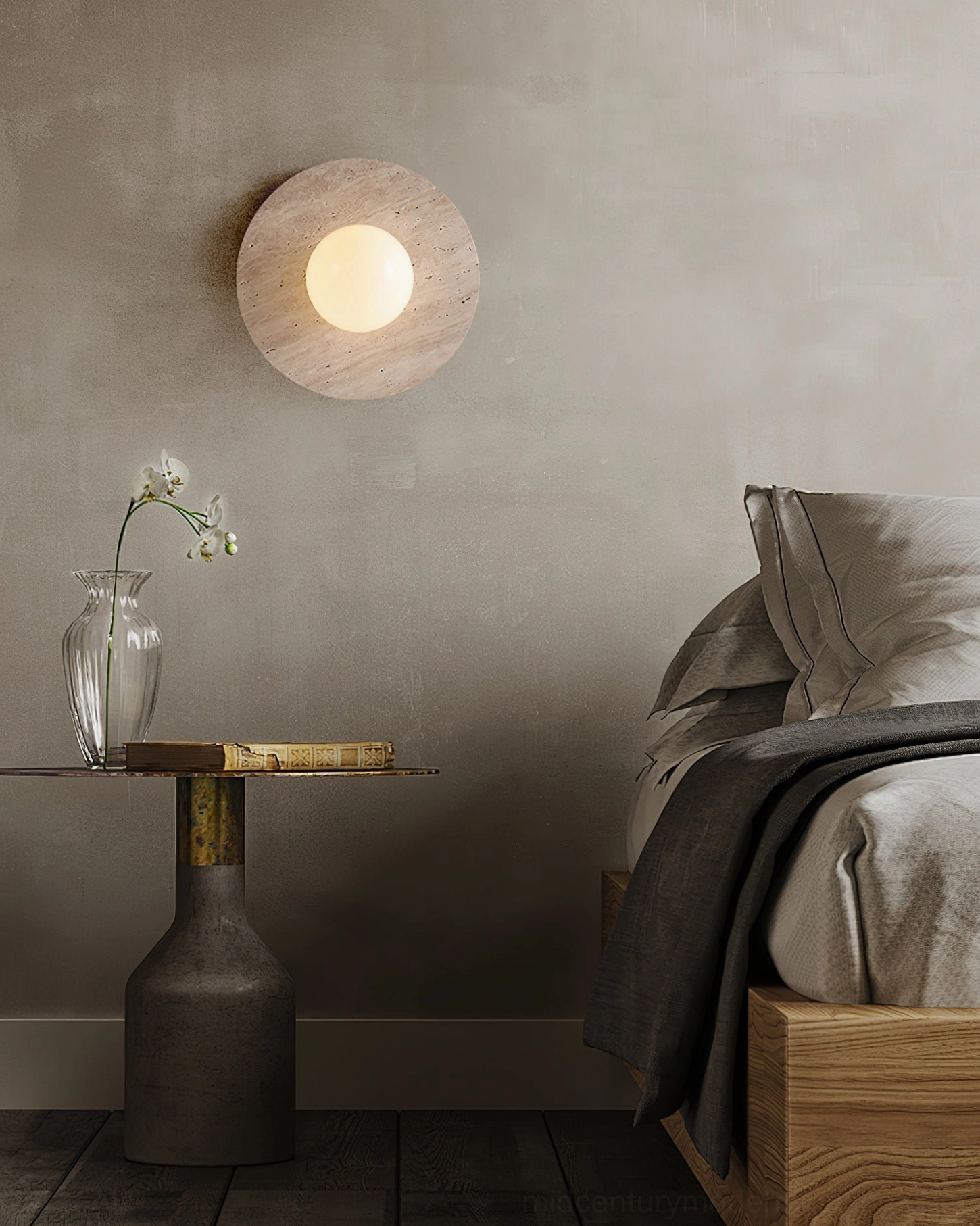 Travertine wall lamp beside bedroom bedside table with orchid plant, cozy bedroom lighting accent
