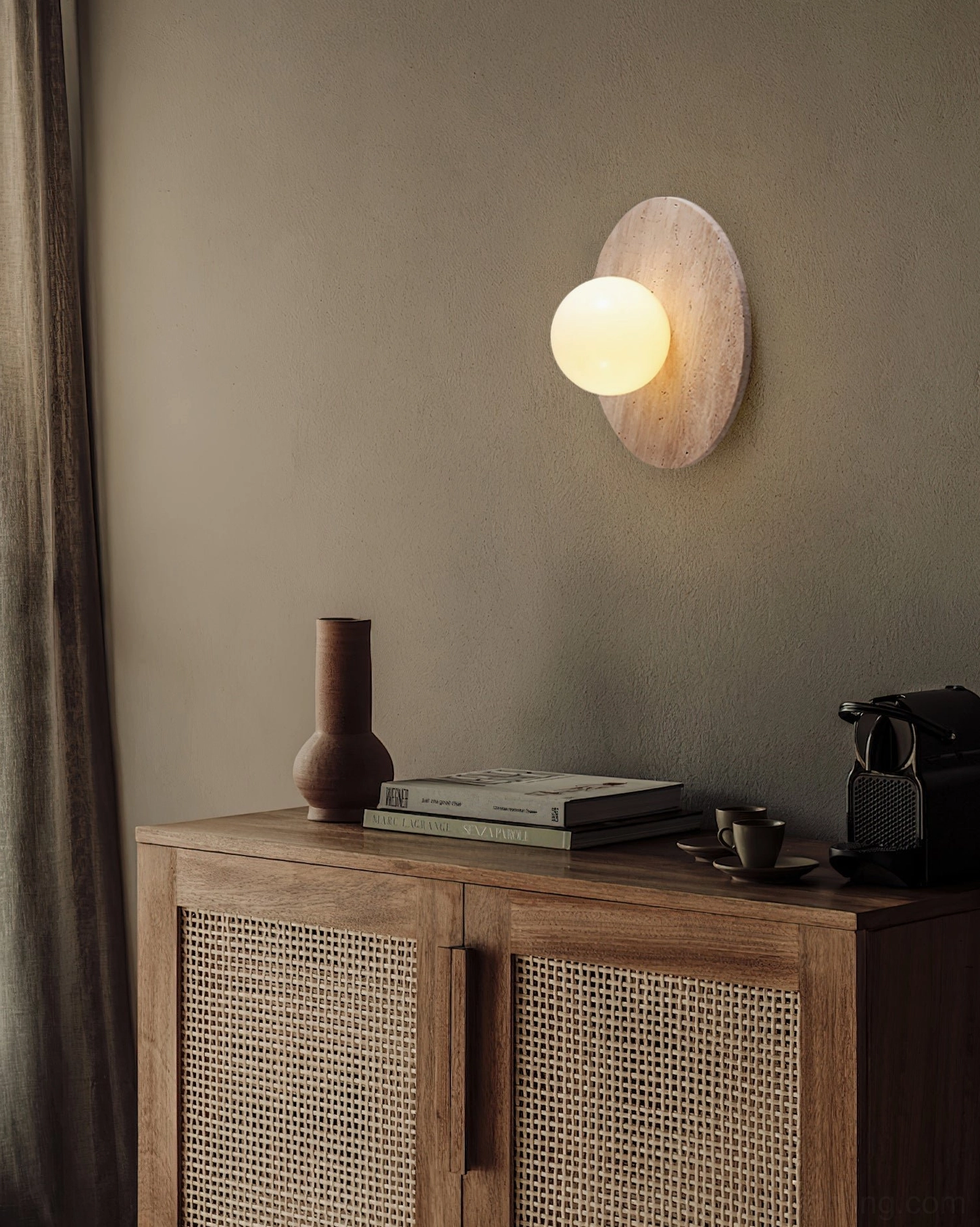 Elira travertine wall lamp displayed near console table with rattan woven cabinet, warm neutral styling