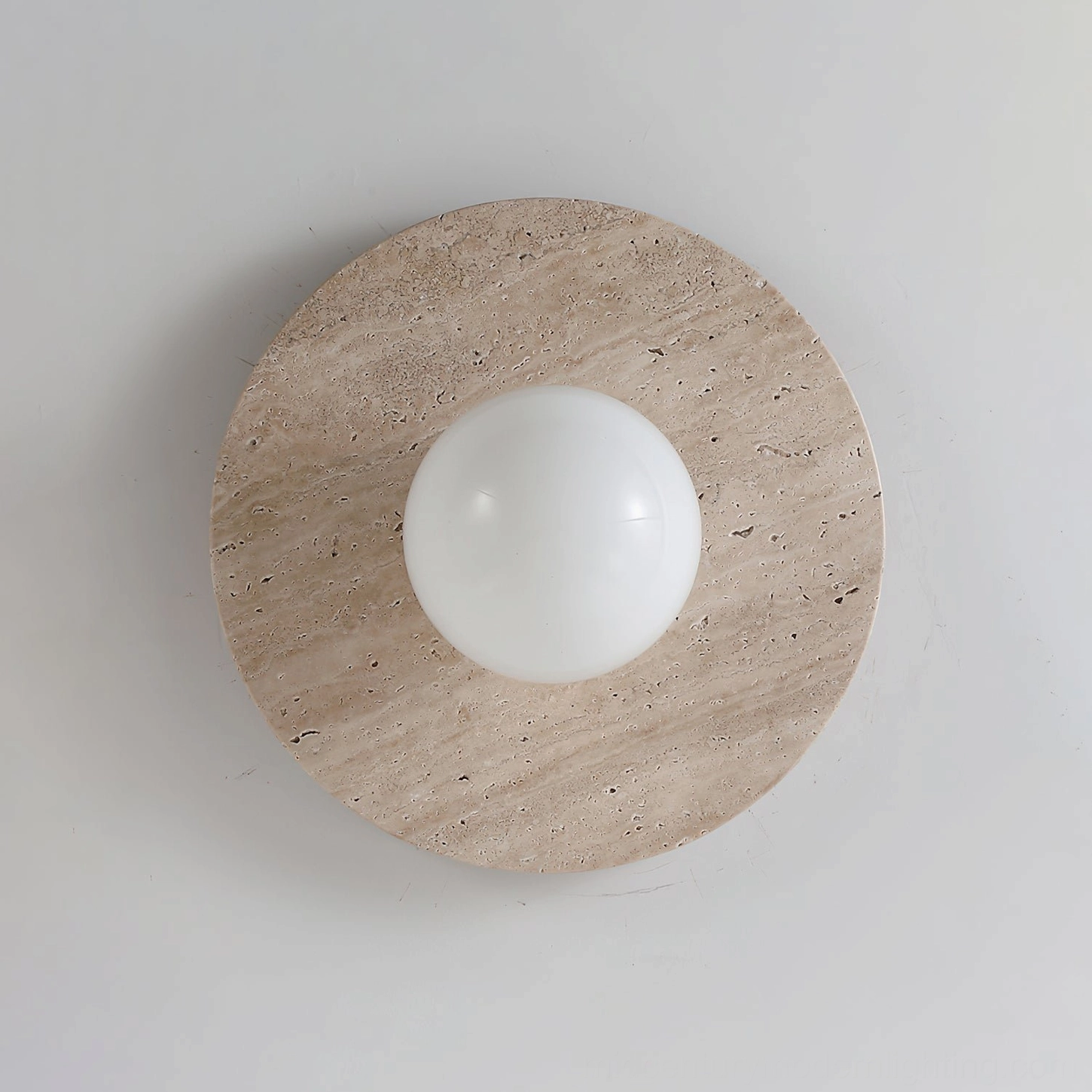 Travertine wall lamp in contemporary interior space demonstrating ambient lighting performance and sculptural form