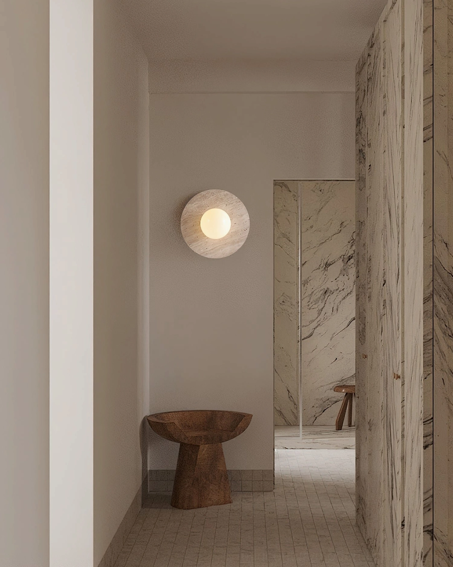 Stone sphere wall lamp in minimalist hallway near marble partition, contemporary luxury interior design