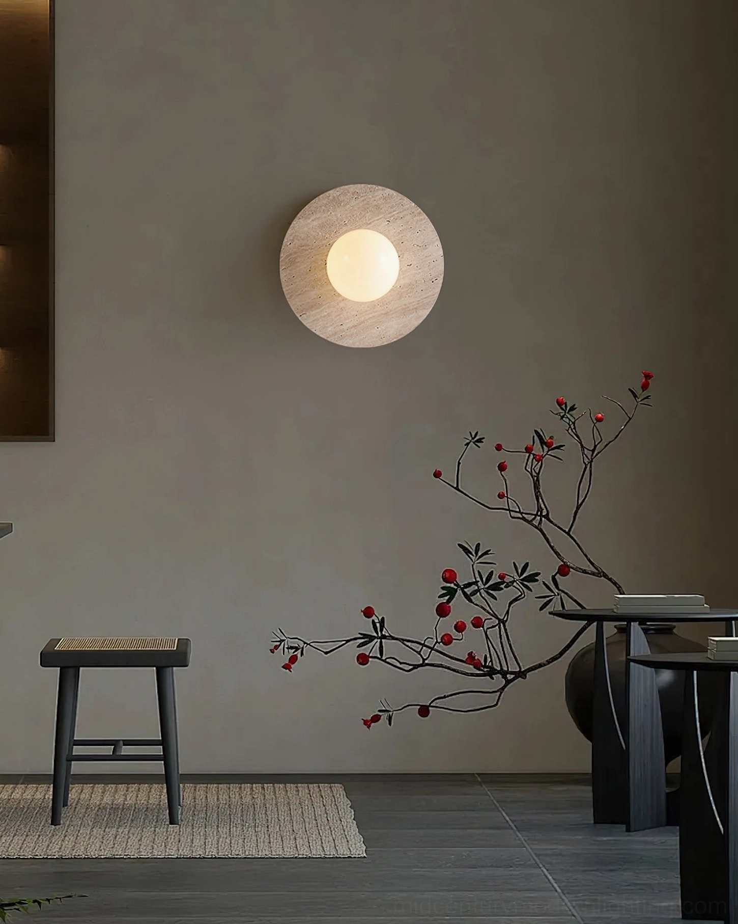 Stone sphere lamp mounted in minimalist living corner with red berry branch botanical accent