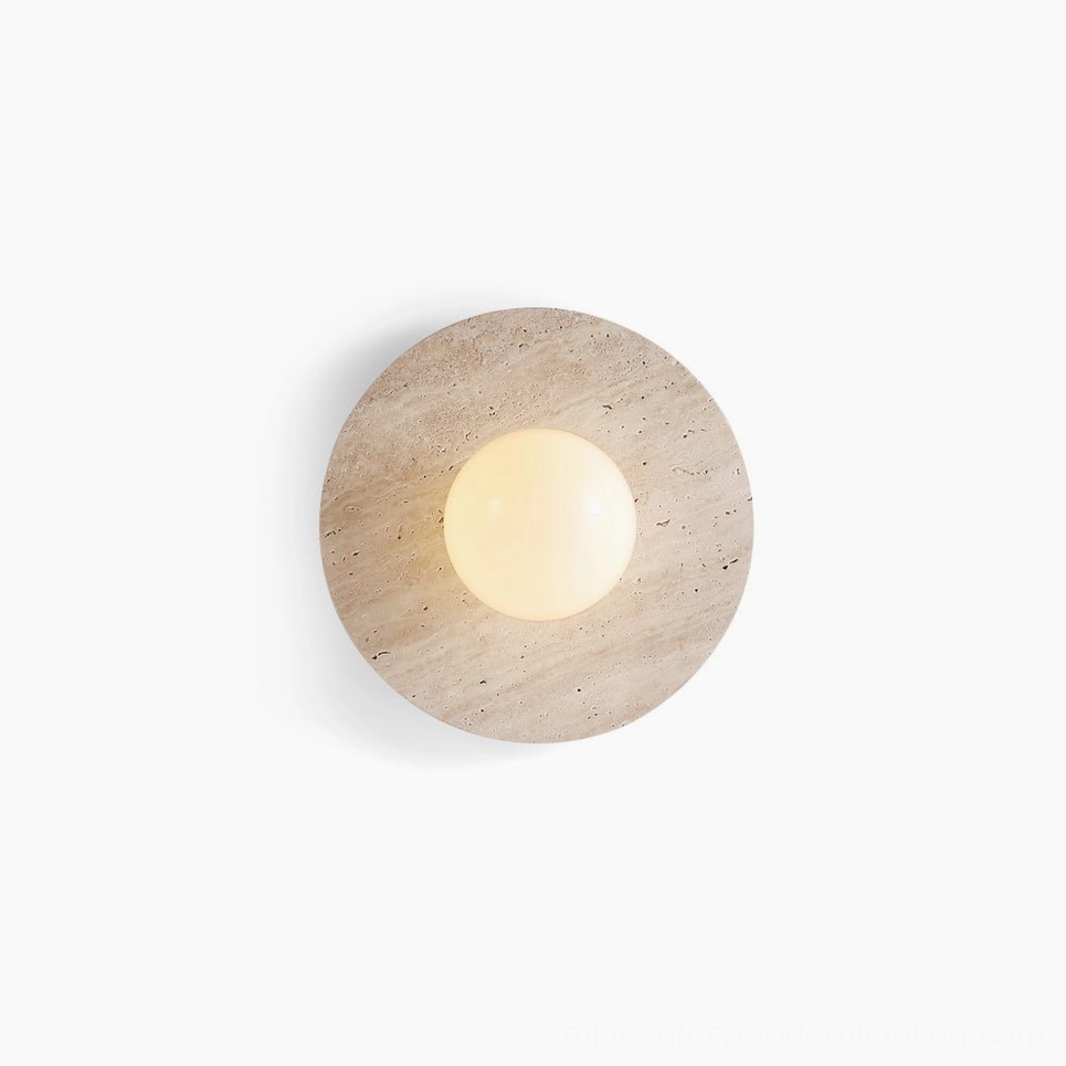 Elira travertine wall lamp with round stone base and glass sphere, front view on white background showing natural stone texture