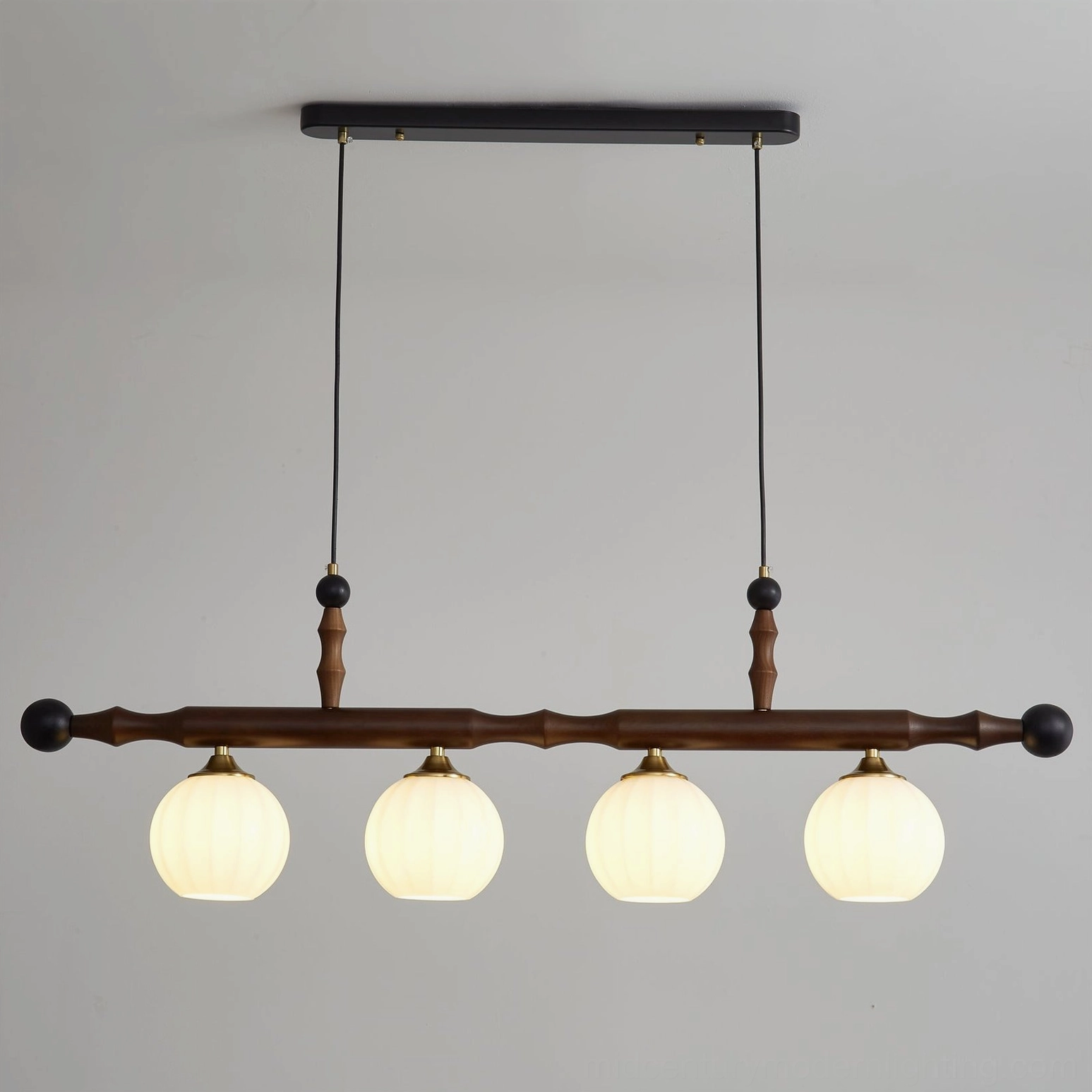 Elisha 4-head wood chandelier with illuminated milky glass globes showing warm light diffusion - front view