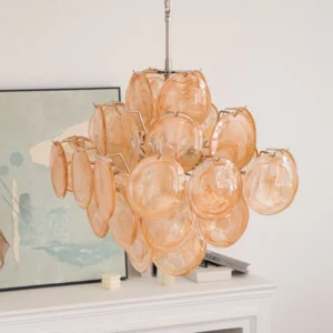 Close-up detail of hand-blown amber glass disc clusters showing light refraction and warm color variations in Murano glass