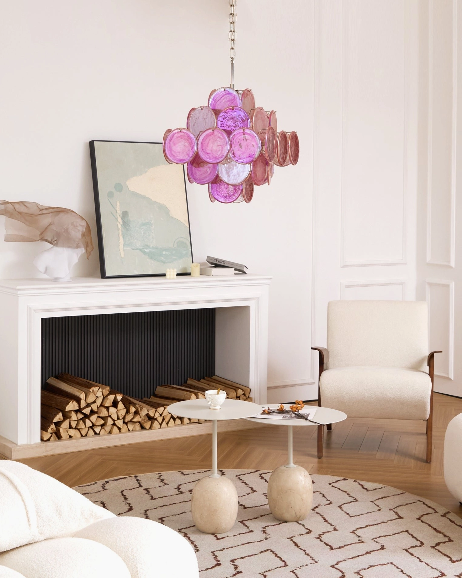 Ellie pink disc Murano glass chandelier distant indoor side view in contemporary luxury home with fireplace