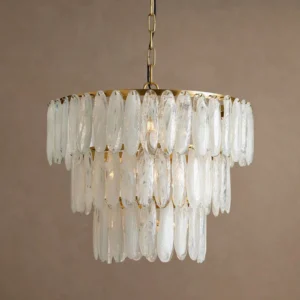 Tiered frosted glass chandelier with warm golden lighting creating soft ambient glow on warm tan studio backdrop, showcasing chandelier illuminated with Edison bulbs