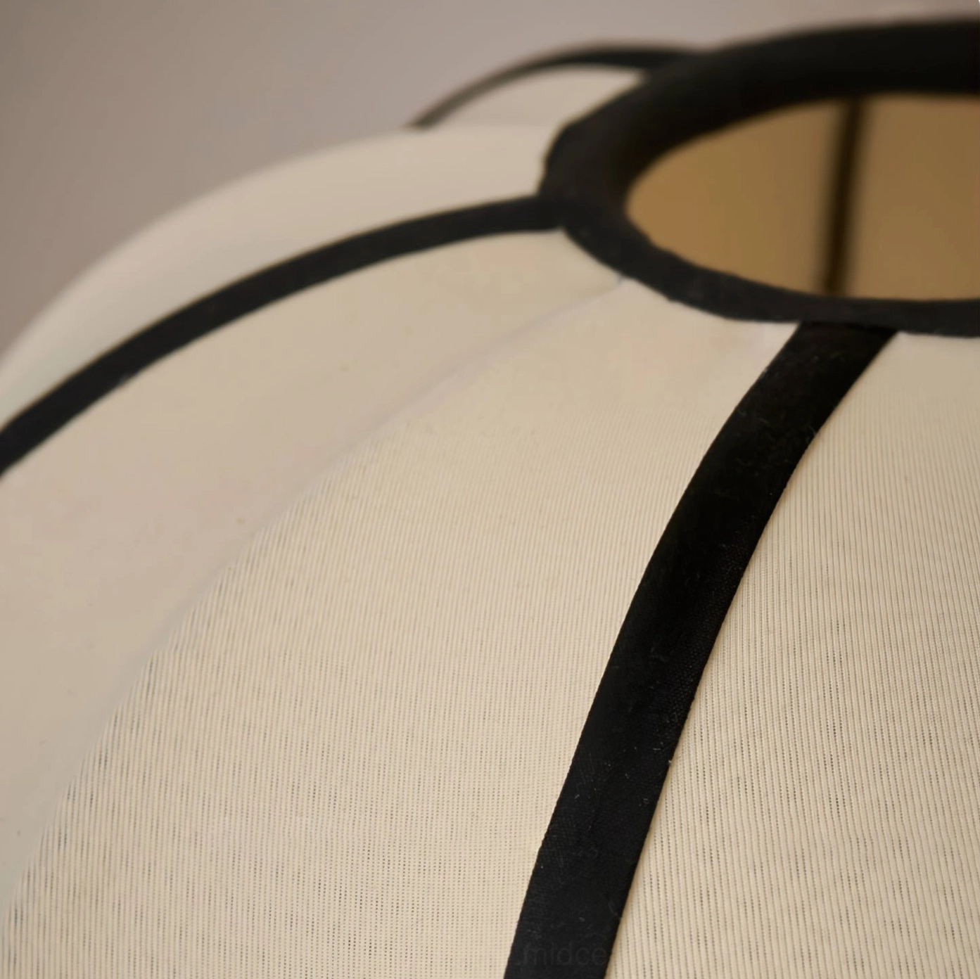Close-up detail of woven fabric shade texture with black geometric trim on Ellos lamp