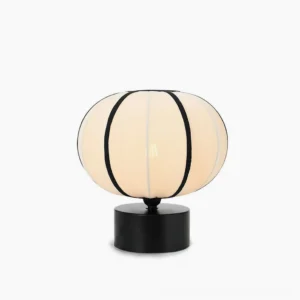 Ellos mid-century modern table lamp with beige fabric shade and black trim, front view on white background