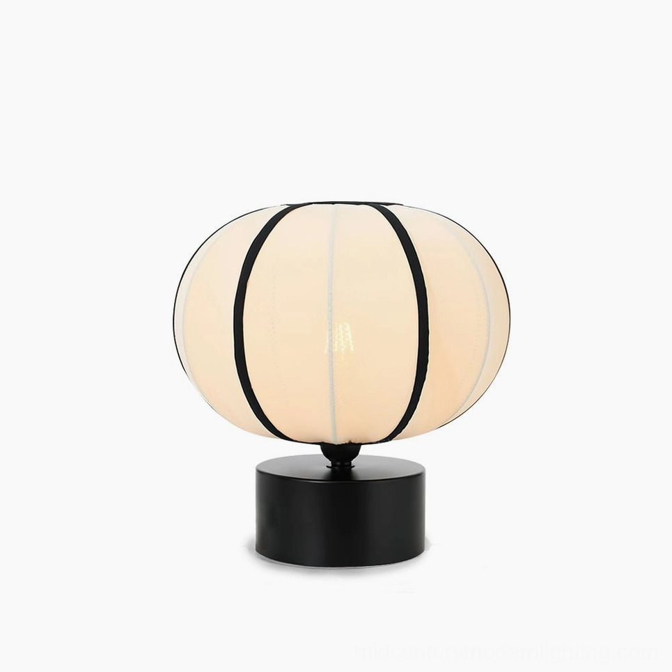 Ellos mid-century modern table lamp with beige fabric shade and black trim, front view on white background