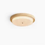 Elora flush mount ceiling lamp with warm wood grain finish and diffused glass shade, top-down minimalist product view