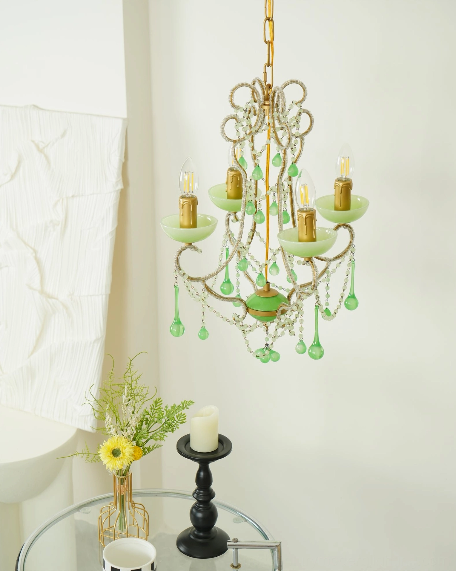 Lush emerald Murano glass chandelier with cascading glass elements in warm gold and green color palette