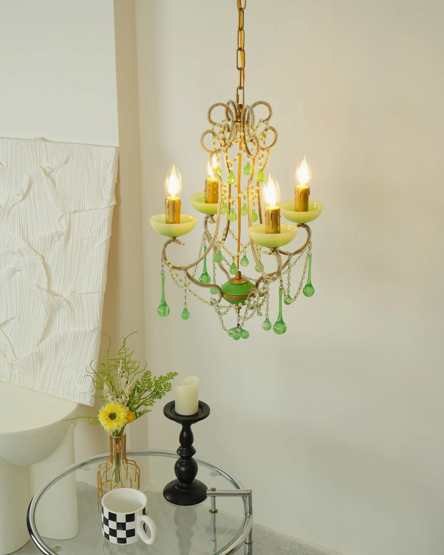 Side view of emerald Murano chandelier with glowing candle bulbs and cascading green glass beads