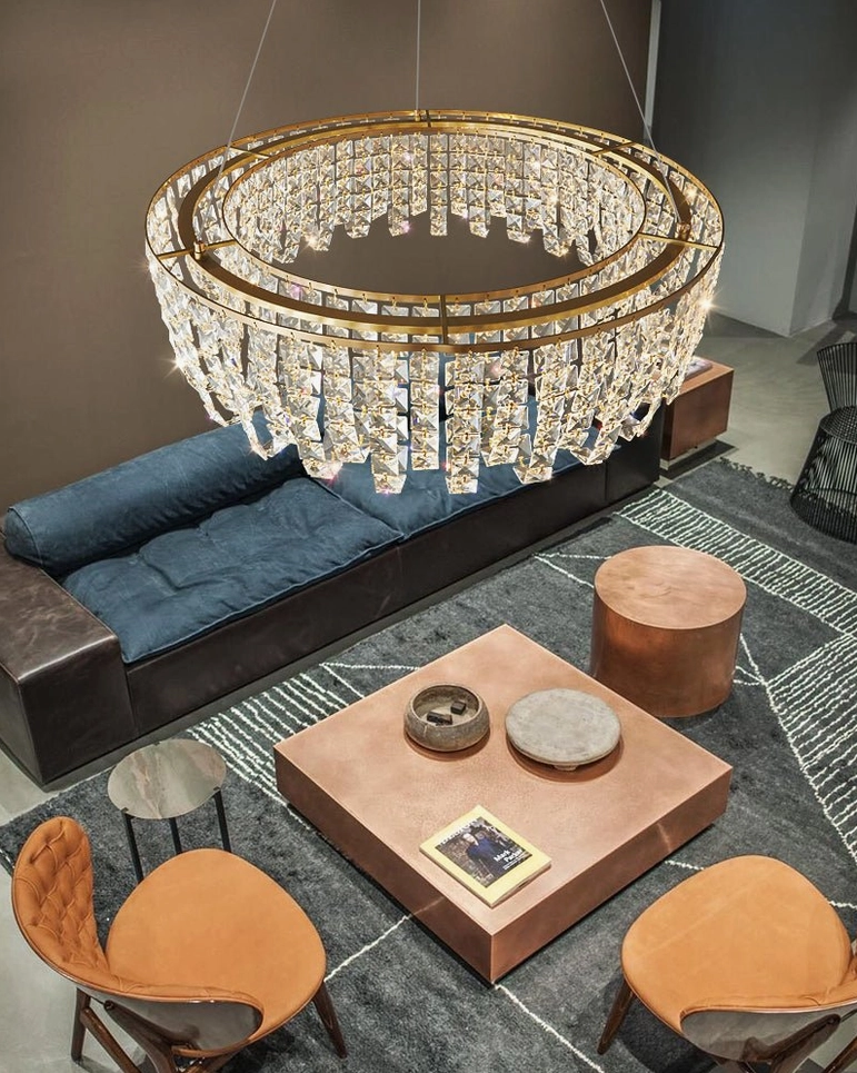 Emory brass chandelier room ambiance showing warm light cast on modern luxury furniture