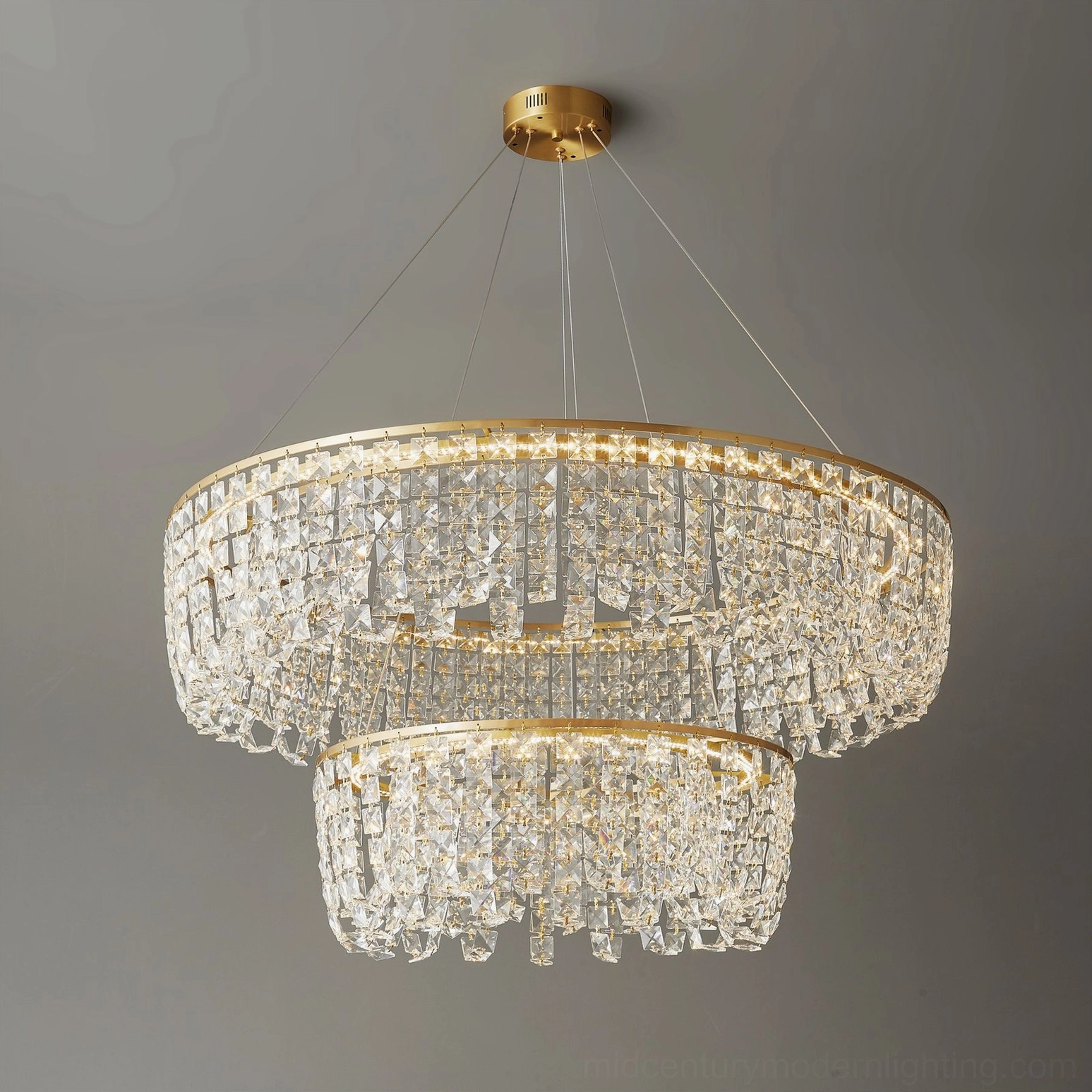 Two-tier crystal chandelier hanging display on grey wall background showing complete silhouette