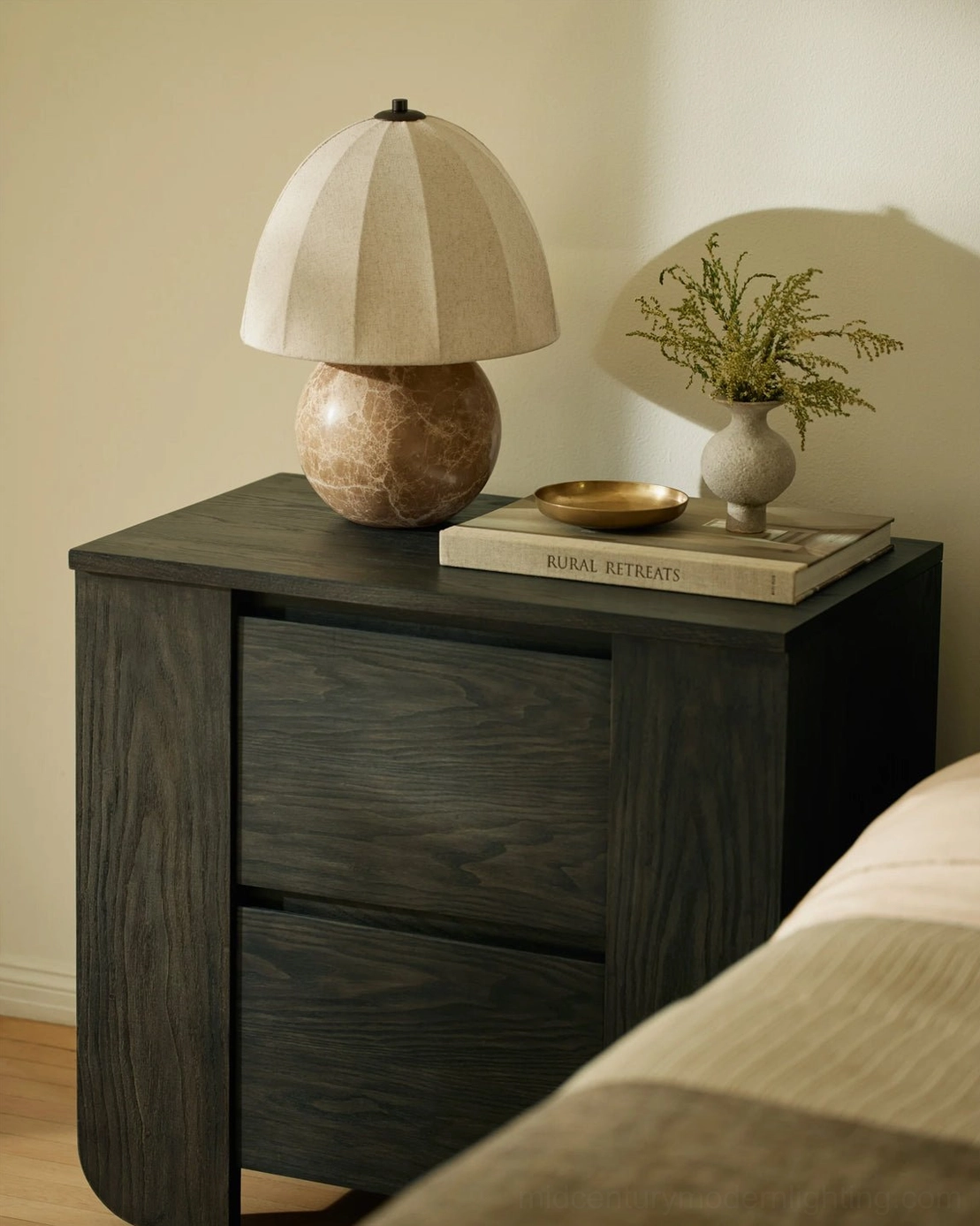 Enora compact organic modern lamp on bedroom nightstand next to bed, warm neutral home aesthetic