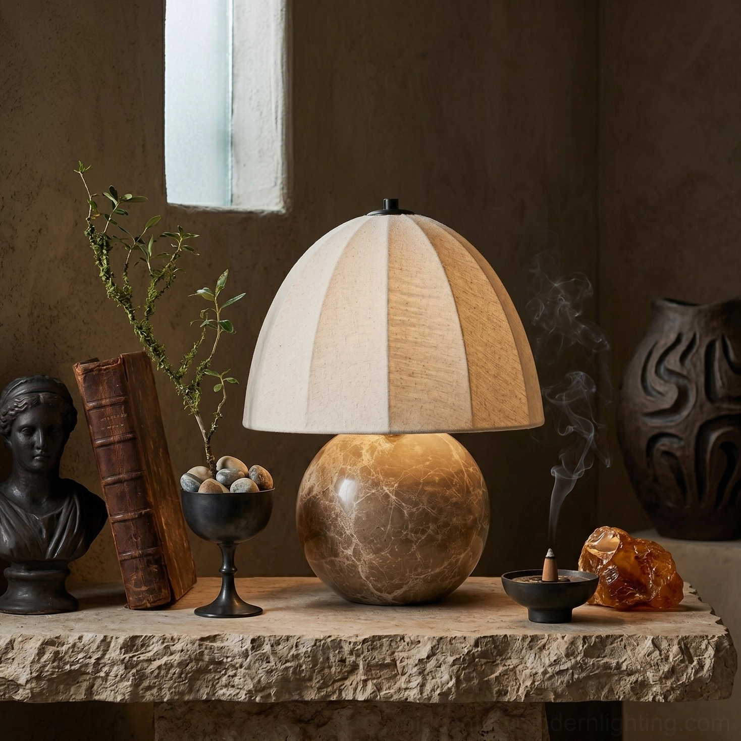 Enora modern stone lamp displayed on vintage console table with decorative accessories, three-quarter perspective