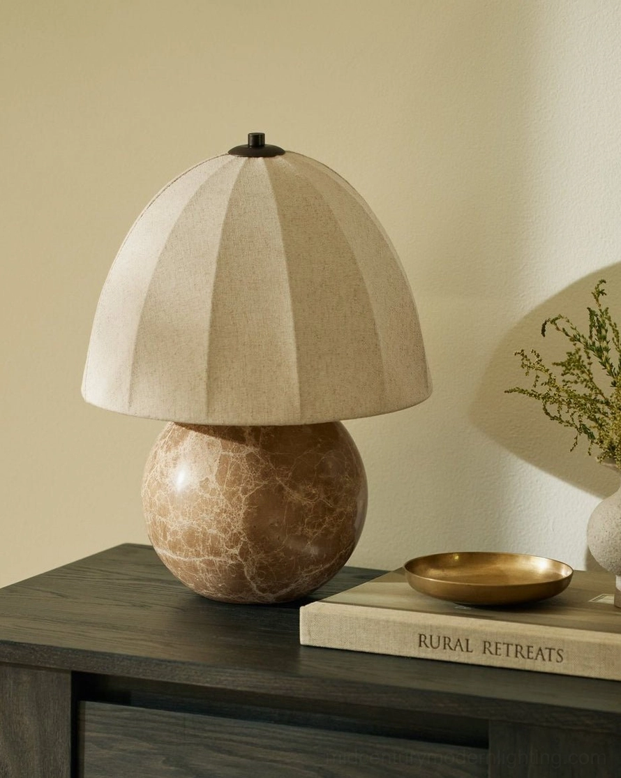 Enora natural stone lamp on dark wood bedside table with metal tray and reading book, minimalist setting