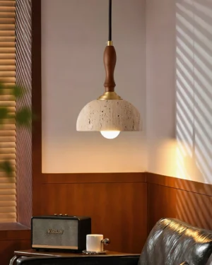 Single travertine pendant light installed in vintage wood-paneled living room with warm ambient glow and natural lighting effect