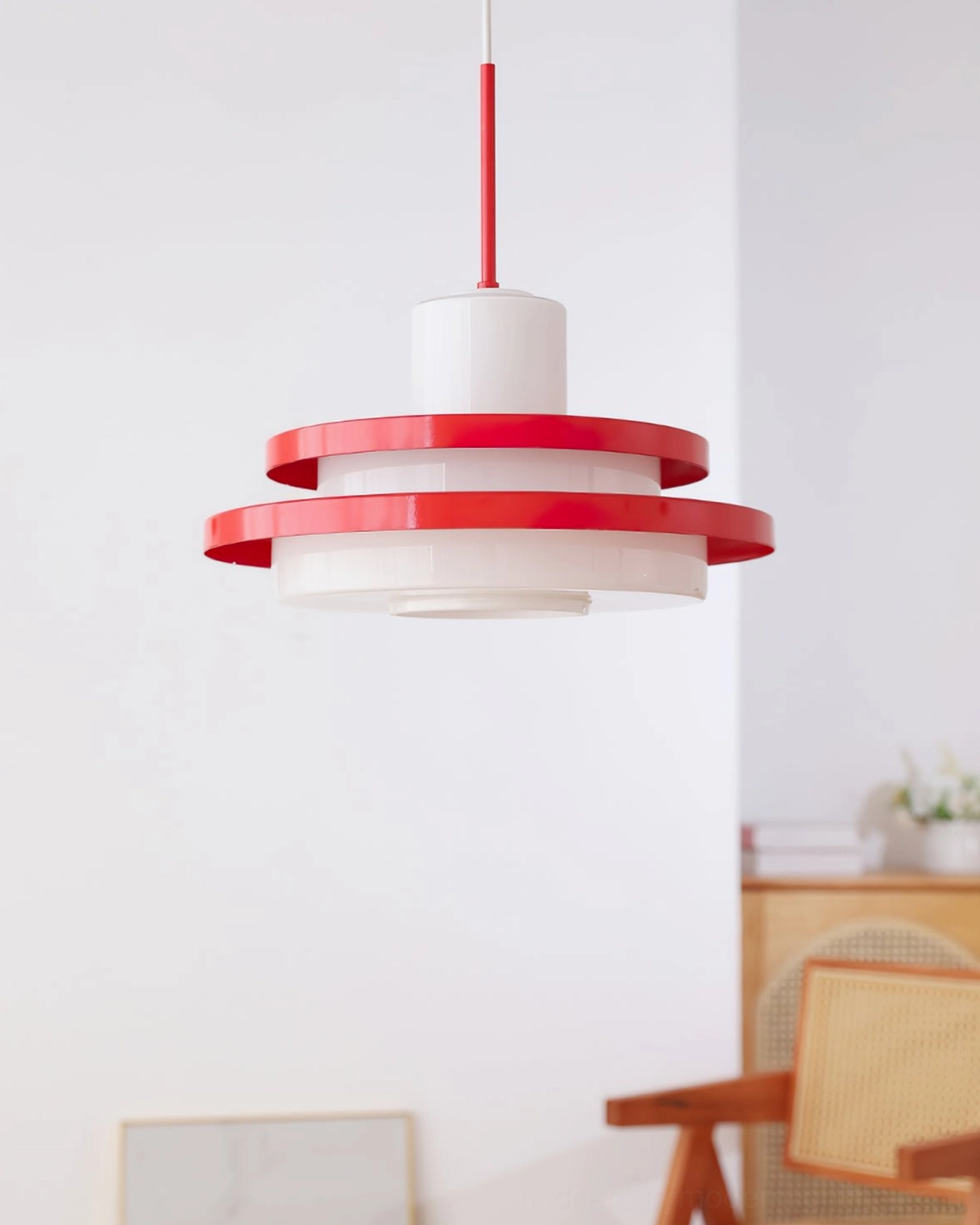 Red and white minimalist pendant lamp front view, symmetrical geometric disc structure