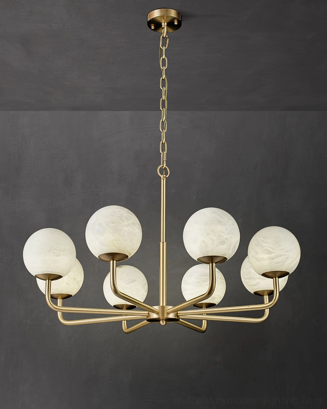Detailed front view of Erich chandelier showing spoked brass arms and frosted glass globe shades
