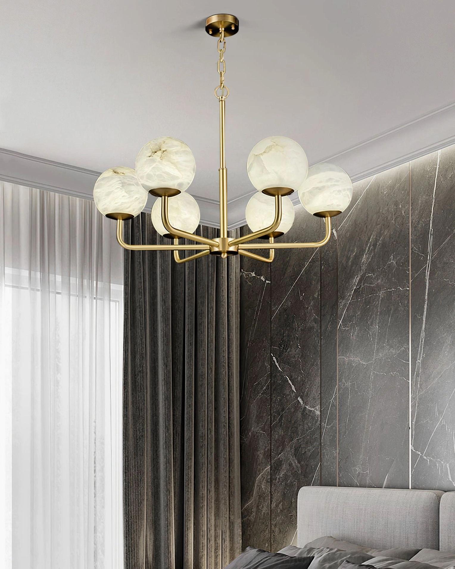 Erich chandelier installed in modern bedroom with marble accent wall and cozy luxury lighting atmosphere