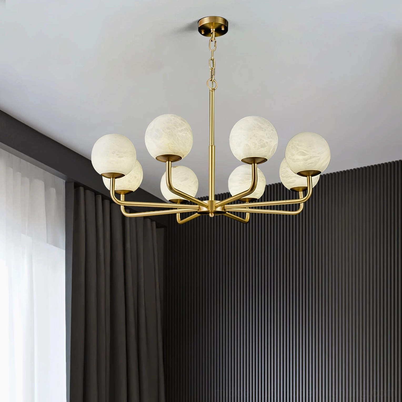 Contemporary living room with Erich chandelier providing warm ambient lighting above minimalist fluted wall