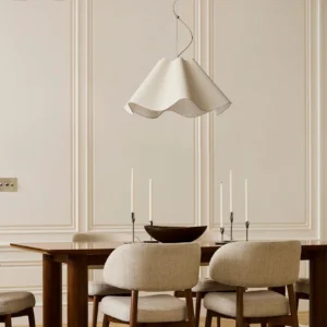 Ethereal Pendant Light suspended above formal dining table in French-inspired neutral interior, overhead perspective showing warm ambient illumination and elegant decor styling