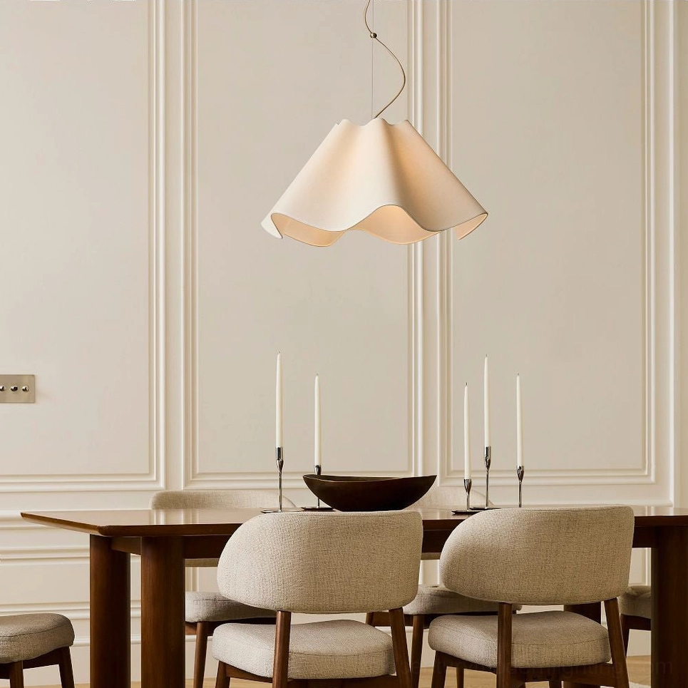 Lit Ethereal Wavy Pendant Lamp glowing softly in modern dining room interior, overhead view demonstrating warm light diffusion through cream fabric shade