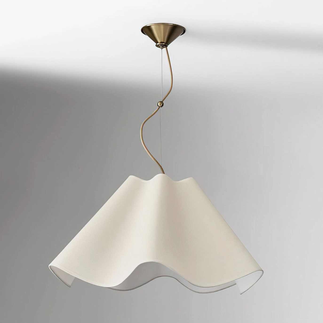 Ethereal Wavy Fabric Pendant Lamp with matte brass curved suspension rod, three-quarter front view against gradient grey studio background