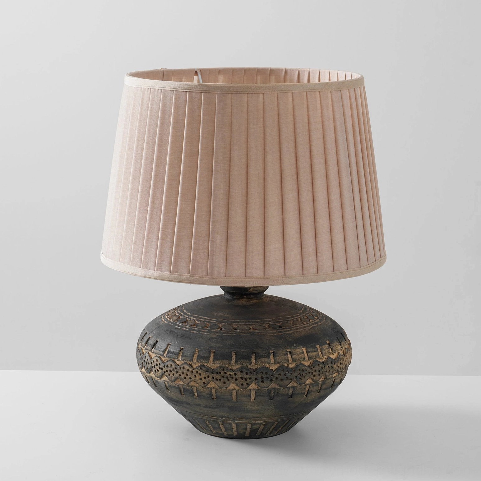 Etta ceramic table lamp showcase featuring textured base and linen shade in contemporary interior setting
