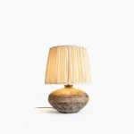 Etta ceramic table lamp with textured base, three-quarter front view showcasing embossed geometric detailing and neutral linen shade
