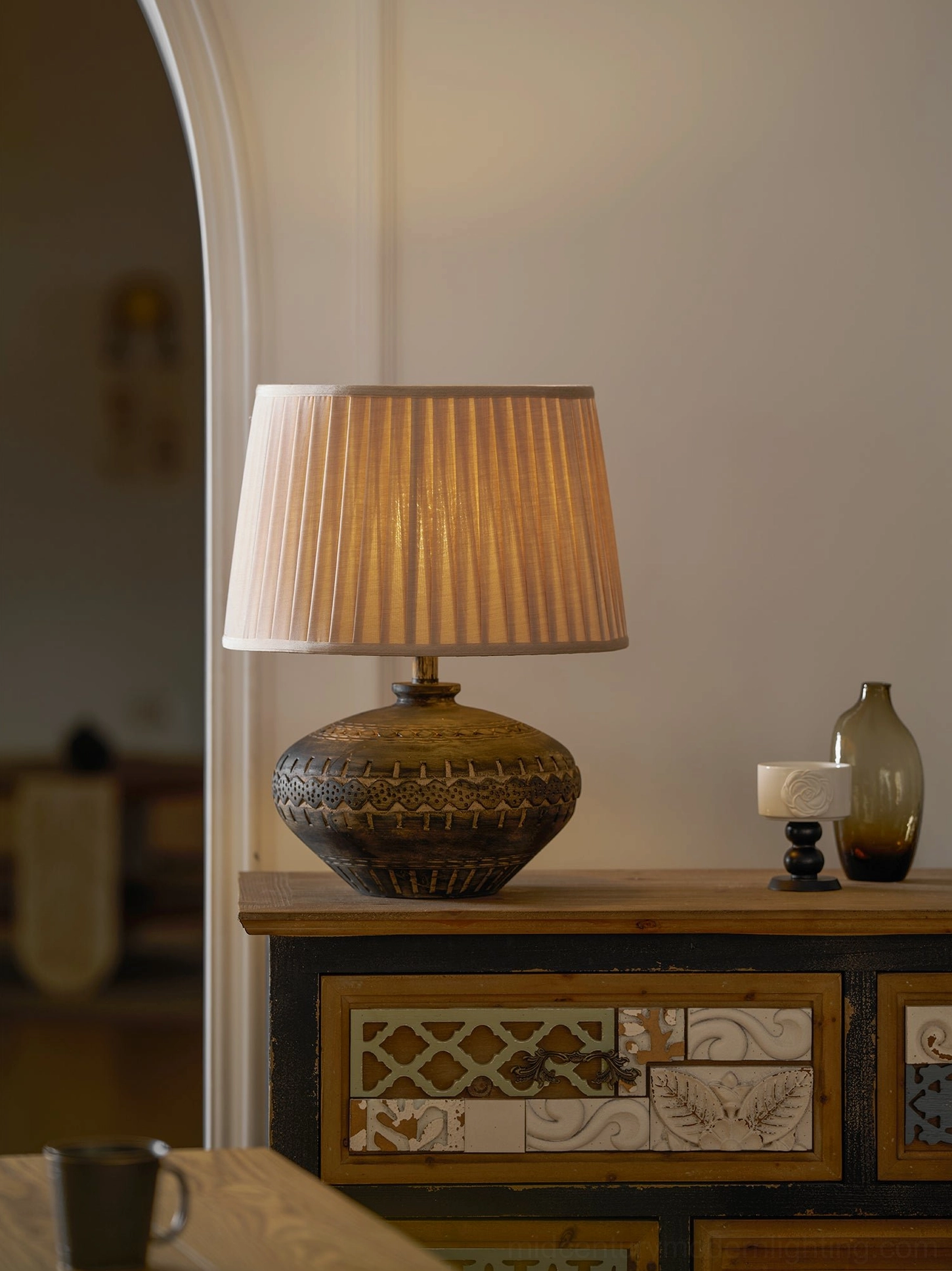 Etta table lamp with embossed ceramic base showcasing artisan craftsmanship and warm ambient lighting quality