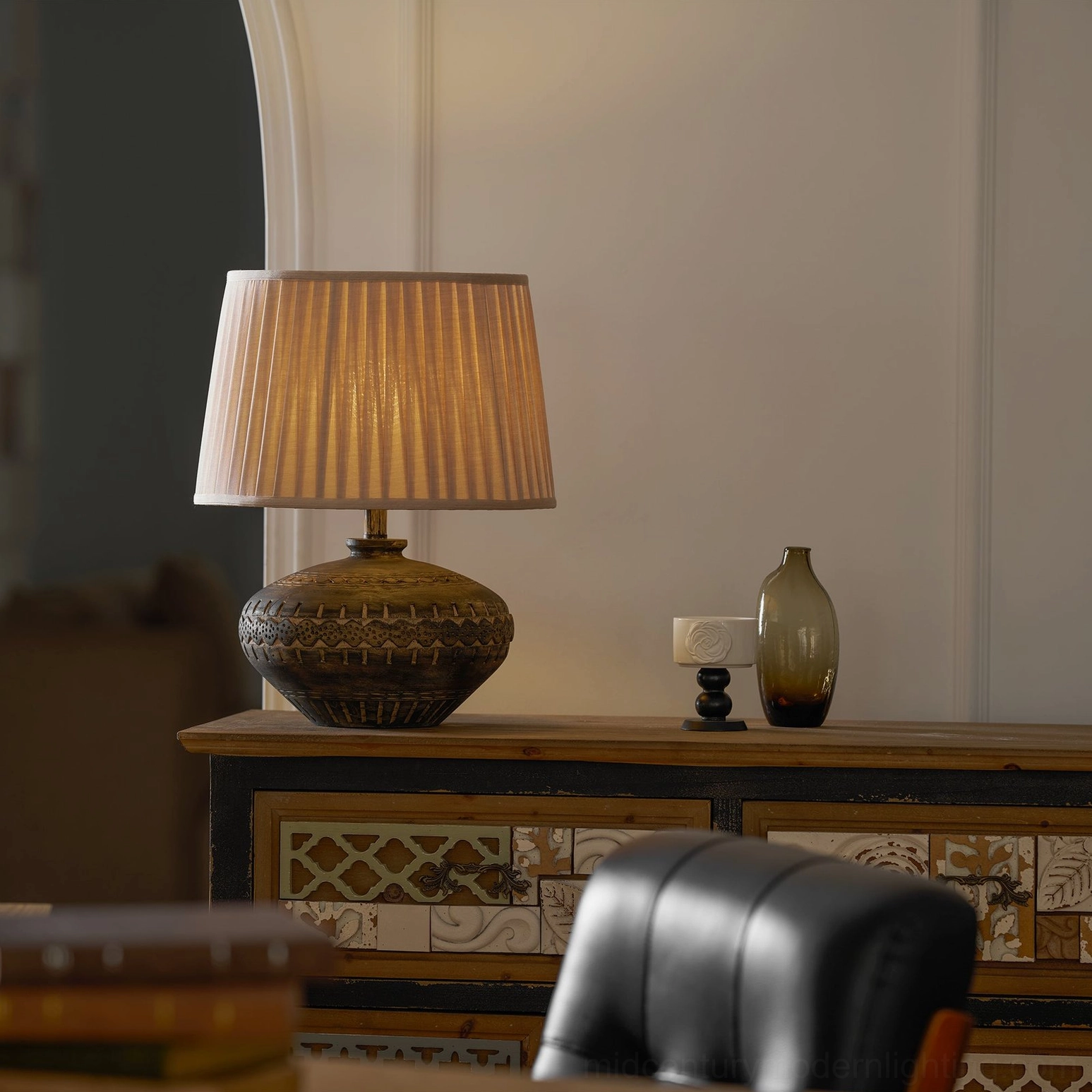 Three-quarter side view of Etta ceramic table lamp on home console table in classic rustic vintage interior