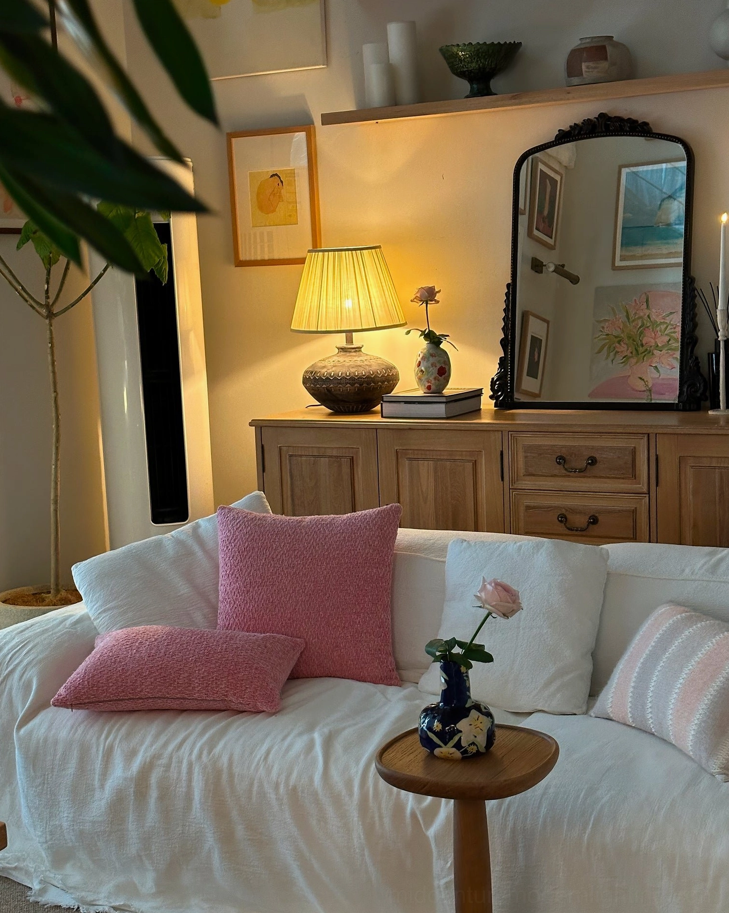 Etta ceramic table lamp positioned in living room sofa area with matching rustic vintage bohemian decor