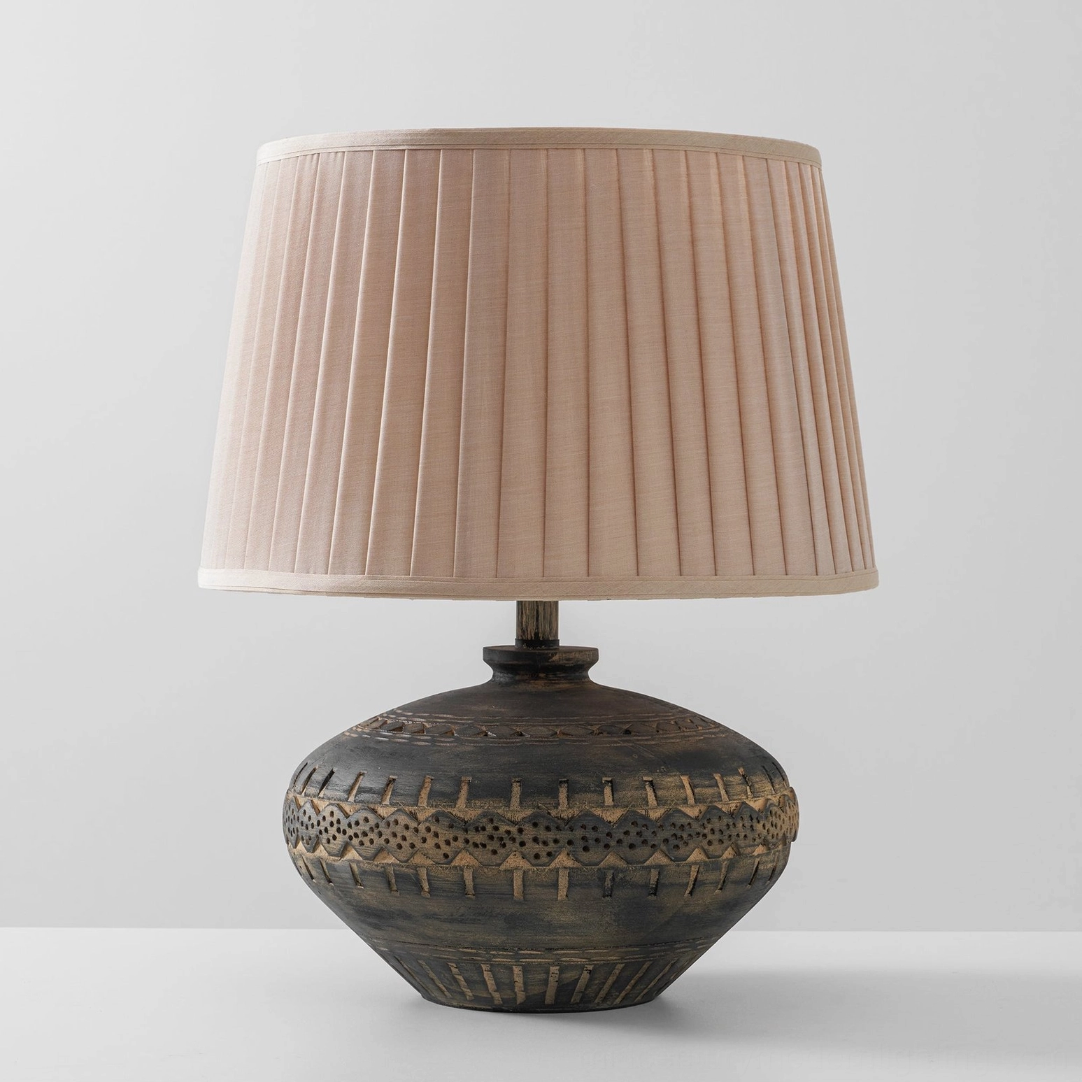 Etta table lamp side profile revealing smooth ceramic base contours and linen shade proportions