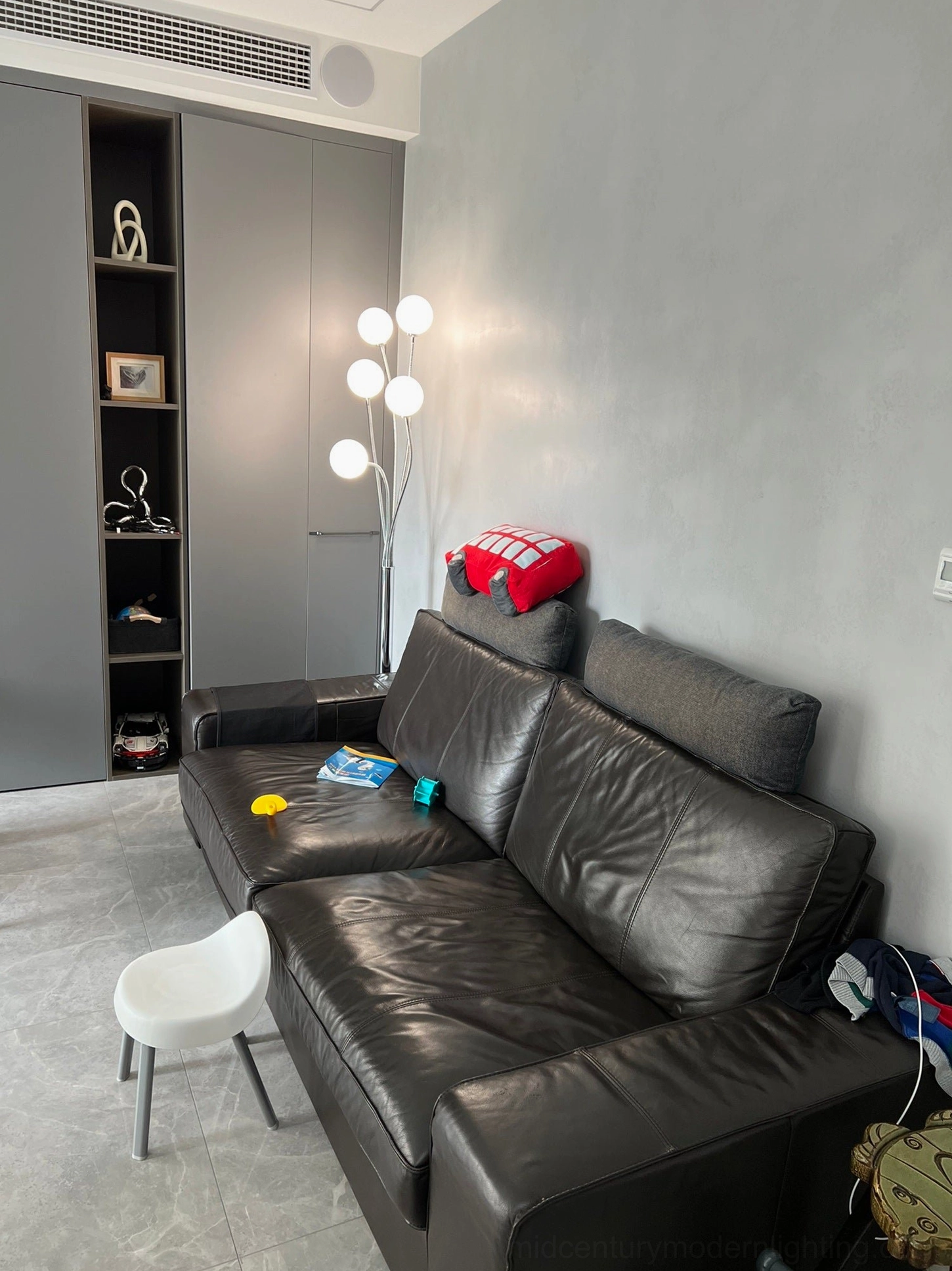 Articulated chrome eyeball floor lamp architectural detail showing swivel arm mechanism and reflective chrome finish