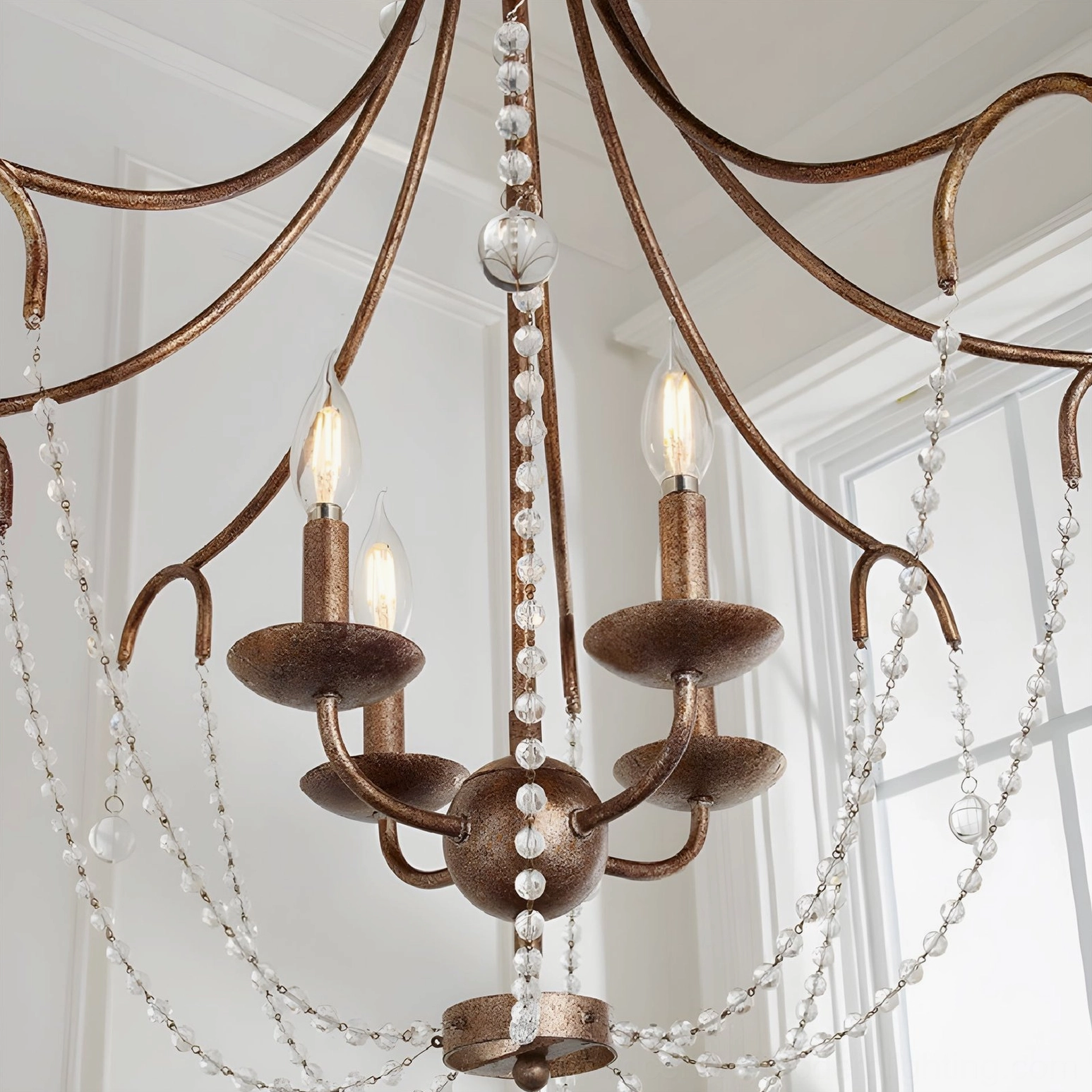 Fabio crystal chandelier architectural detail showing brass curvature and crystal strand arrangement