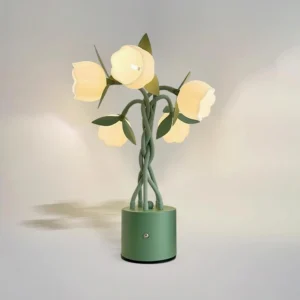 Lit faira tulip lamp showcasing warm glowing white flower lights with green metal stem architectural detail