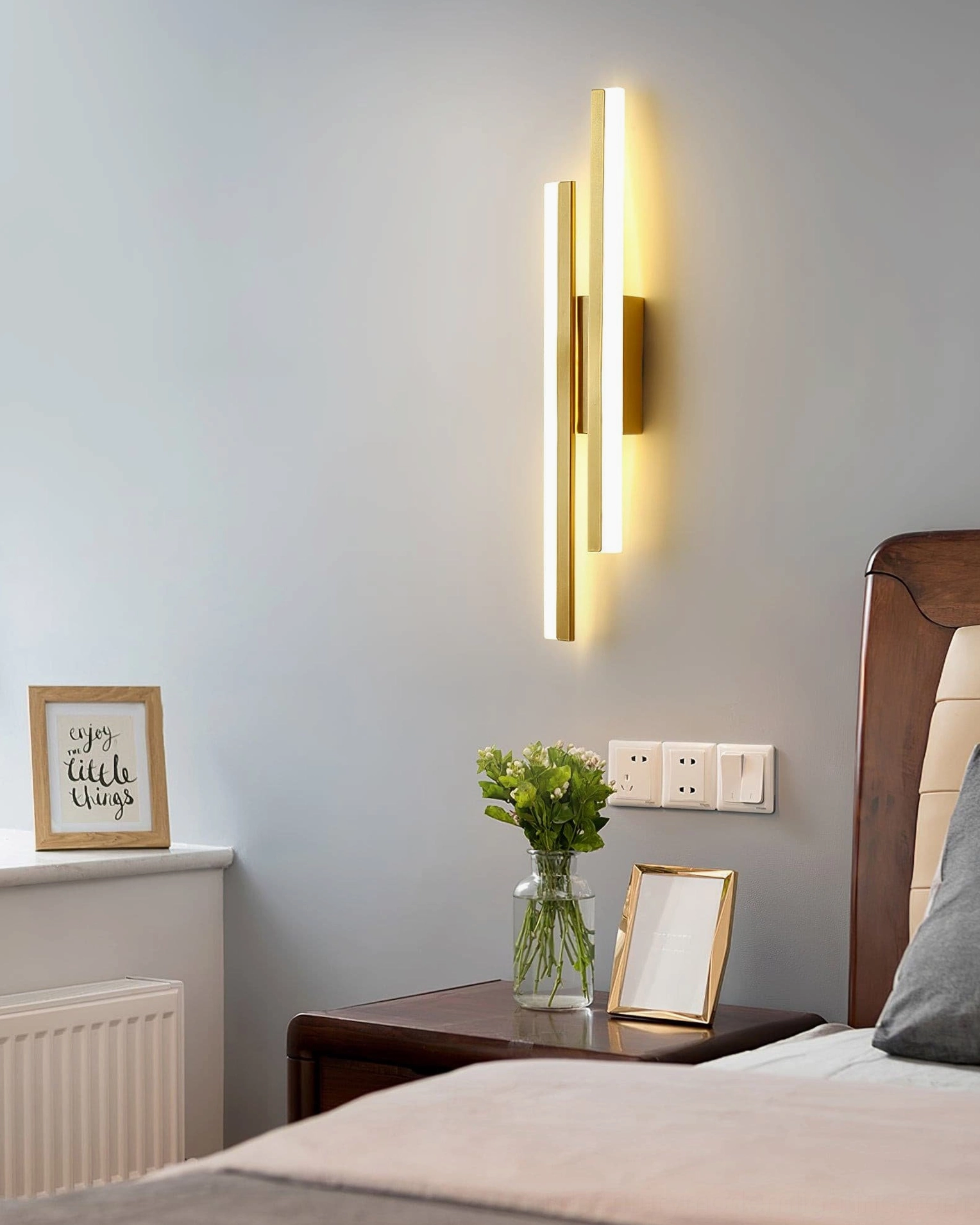 Architectural detail of Fallon wall lamp showing symmetrical pipe configuration and acrylic diffusers