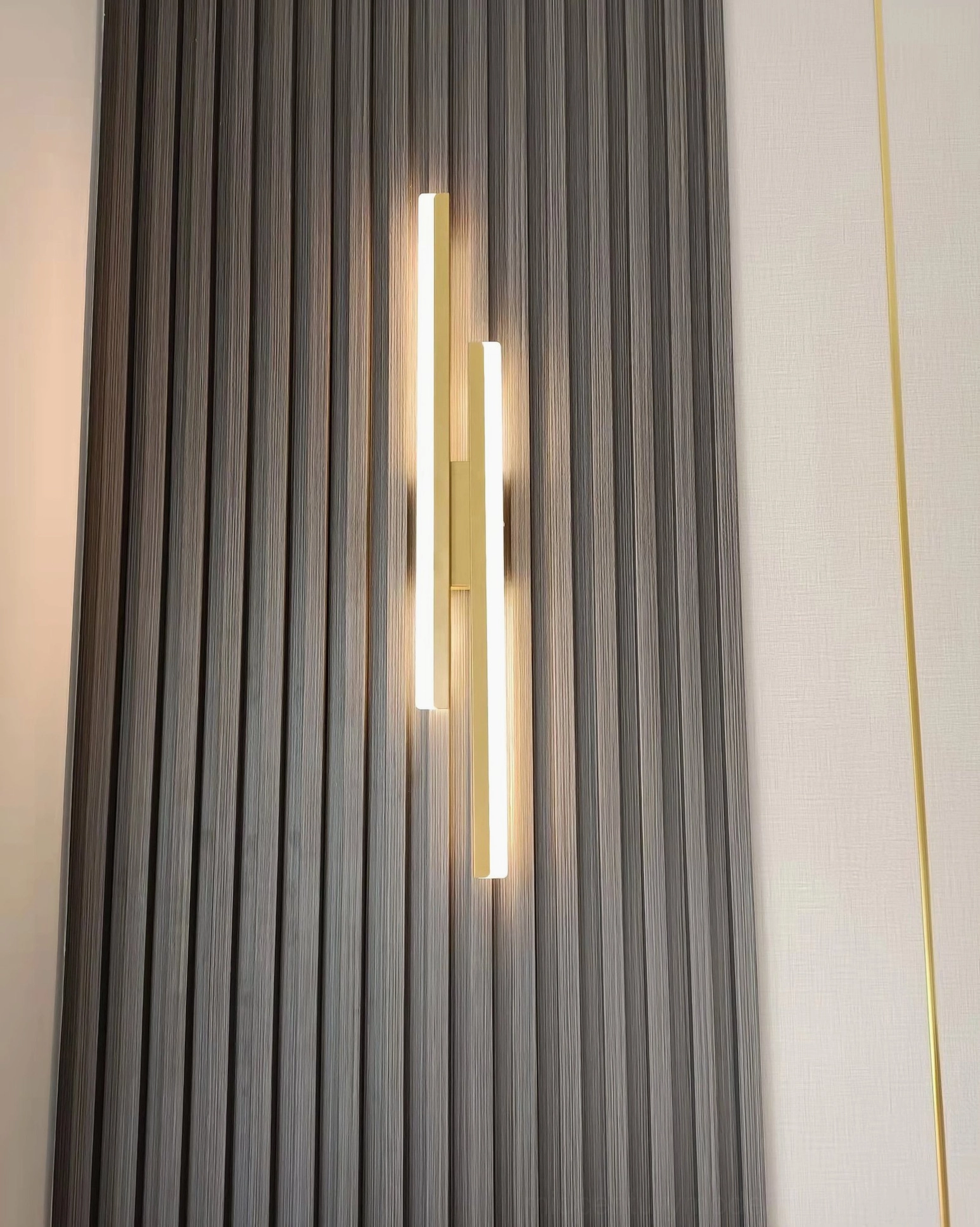 Fallon minimalist sconce paired with modern interior accessories demonstrating styling versatility