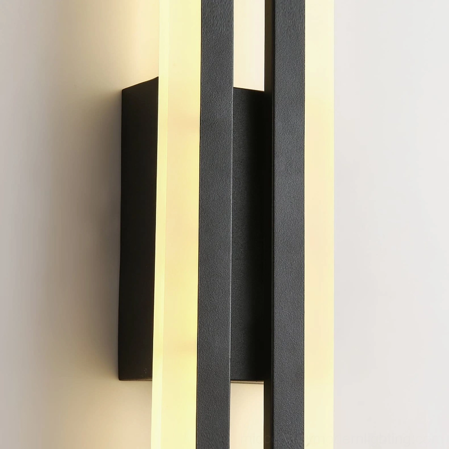Side detail view of dual-tube Fallon wall sconce with frosted acrylic and warm glow