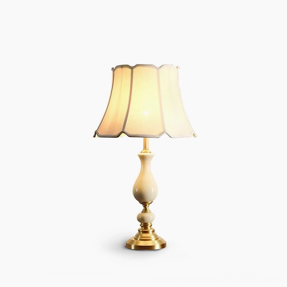 Fangio mid-century modern table lamp with ivory ceramic base and brass accents, front studio view