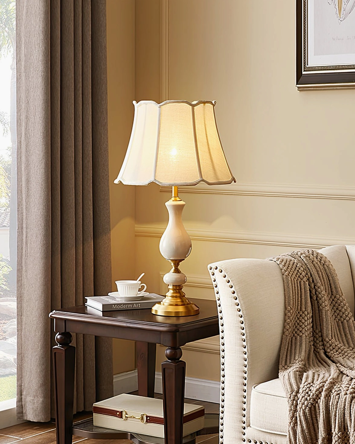 Fangio mid-century modern lamp in warm neutral tones with coffee set and books near armchair