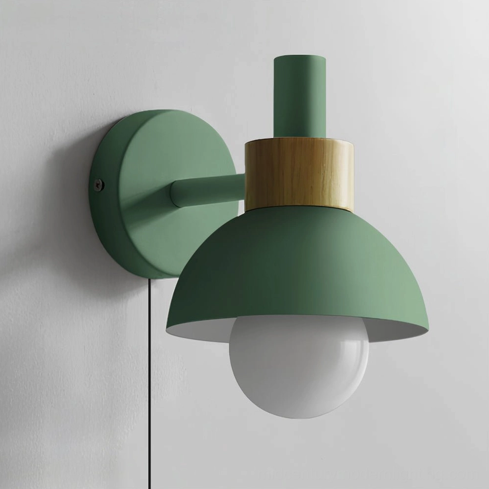 Fanta green plug-in wall lamp with natural wood detail in contemporary bedroom styling