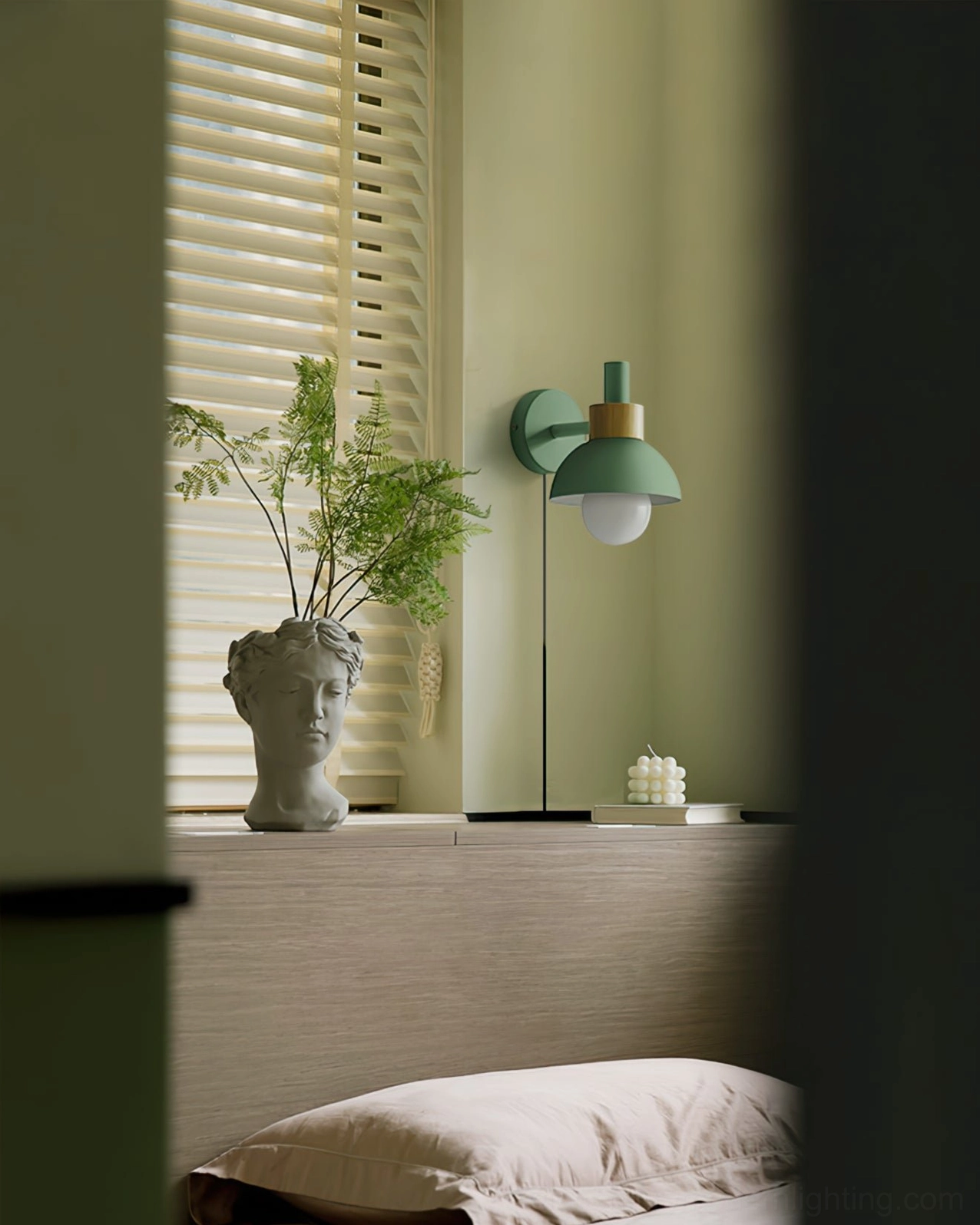 Fanta green plug-in wall sconce in bedroom window nook with matte dome shade