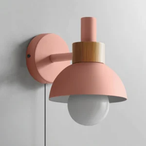 Fanta pink wall sconce side angle showing dome shade and exposed bulb with wood bracket